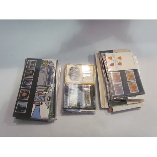 4476 - Approximately 170 first day covers together with approximately 110 mint stamp packs