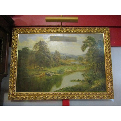 4021 - An oil on canvas depicting a pastoral landscape, gilt framed with light fitting, 60cm x 90cm image s... 