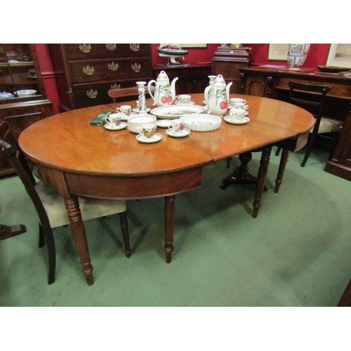 4064 - A 19th Century mahogany D-end dining table with extra leaf and brass connectors on turned and taperi... 