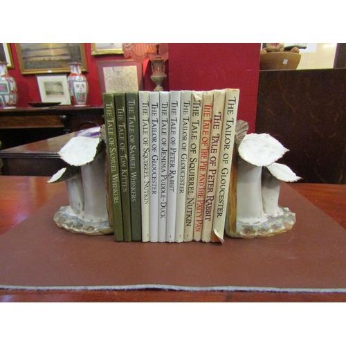 4069 - A pair of handmade pottery book-ends in the form of toadstools together with a selection of Beatrix ... 