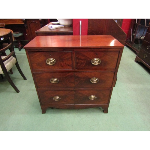 4070 - A 19th Century and later flame mahogany chest of two short over two long drawers with brass oval pla... 