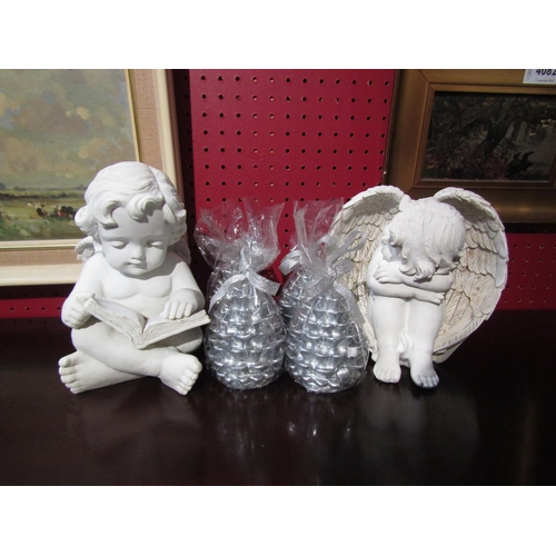 4083 - Two seated cherubs together with a set of four fir cone candles