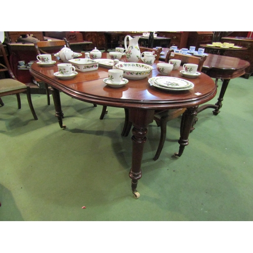 4105 - A 19th Century mahogany extending dining table with extra leaf on turned legs and castors, 75cm tall... 