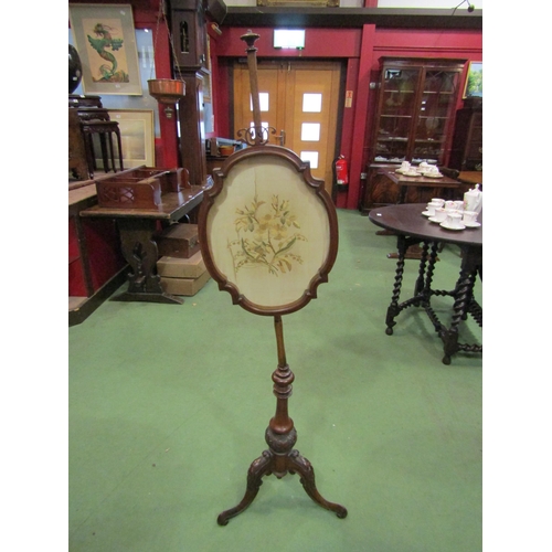 4112 - A mahogany pole fire screen with silk floral embroidery (a/f) on tripod scrolled feet   (E) £15-25