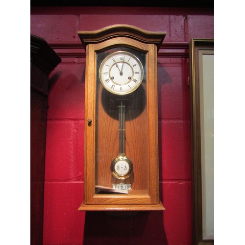 4116 - A Hermle wall hanging clock with key and pendulum