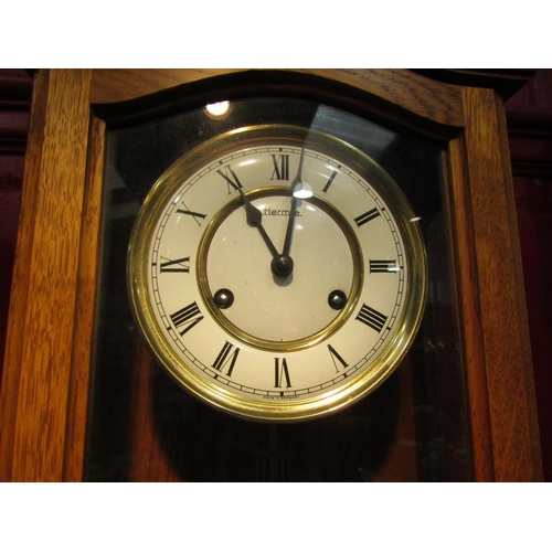 4116 - A Hermle wall hanging clock with key and pendulum