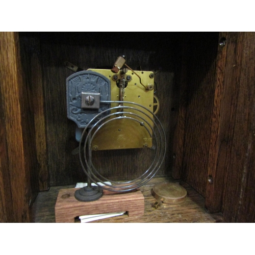 4120 - An oak cased 7-day bracket clock with key and pendulum