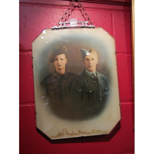 4127 - A 1940's coloured photograph of an airman and a soldier, chrome finial, bevel glass (water stained l... 