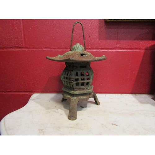 4150 - A cast iron pagoda style garden lantern, 26cm tall