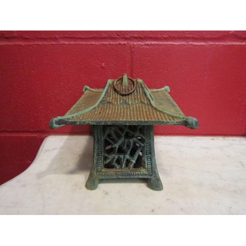 4151 - A cast iron pagoda style garden lantern, 19cm tall