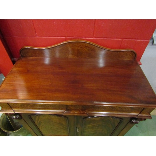 4155 - A circa 1840 flame mahogany chiffonier, the raised serpentine upstand over two frieze drawers and tw... 