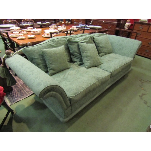 4156 - A green floral patterned Knole three seater sofa with turned beehive finials, the deep arms over tap... 