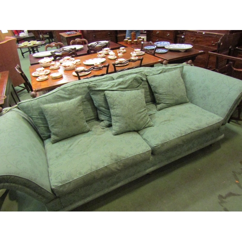 4156 - A green floral patterned Knole three seater sofa with turned beehive finials, the deep arms over tap... 