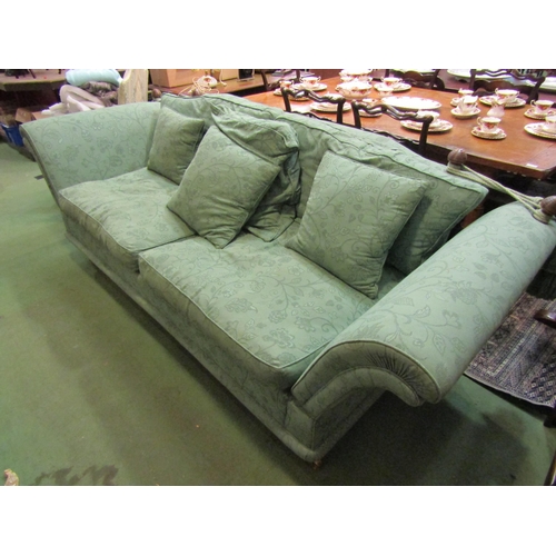 4156 - A green floral patterned Knole three seater sofa with turned beehive finials, the deep arms over tap... 