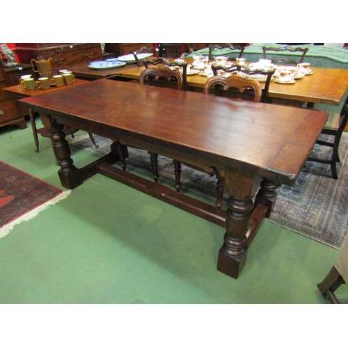 4167 - A 17th Century revival oak refectory dining table with cleated ends over turned legs joined by an H ... 