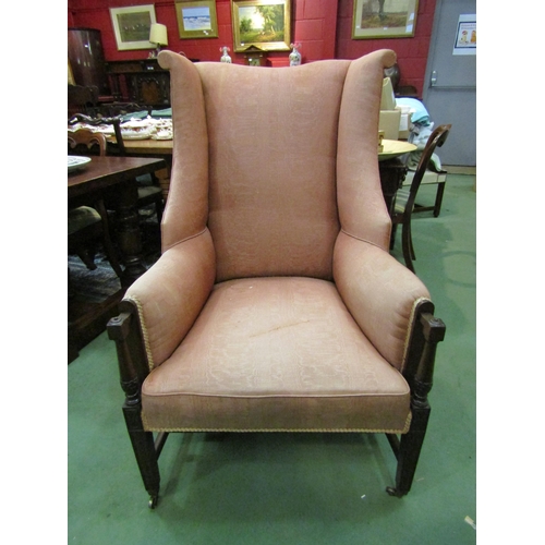 4169 - A circa 1840 mahogany wing back armchair with carved and turned arm supports over square tapering fo... 