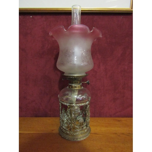 4185 - A late Victorian oil lamp, cranberry tin shade, pierced foliate design base