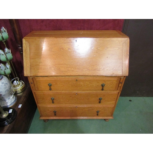 4187 - A 20th Century blonde oak bureau, drop-flap over three graduating long drawers, 102cm tall x 91cm wi... 