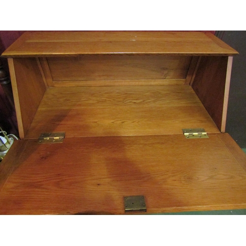 4187 - A 20th Century blonde oak bureau, drop-flap over three graduating long drawers, 102cm tall x 91cm wi... 