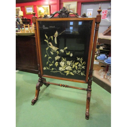 4205 - A circa 1840 walnut fire screen with glazed silkwork panel having carved and turned decoration, the ... 