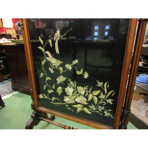 4205 - A circa 1840 walnut fire screen with glazed silkwork panel having carved and turned decoration, the ... 