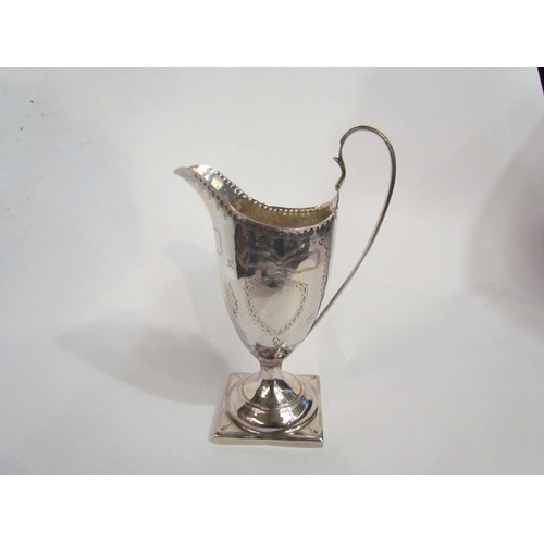 4326 - A Charles Hougham silver helmet form cream jug, bright-cut patterns, vacant cartouches, on square ba... 