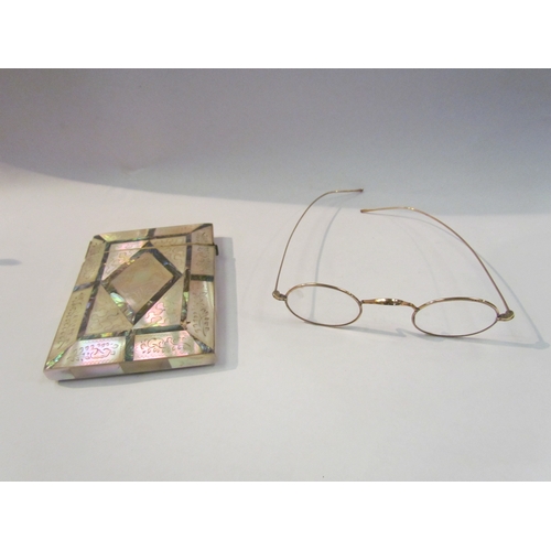 4347 - A pair of spectacles marked '10ct' together with a mother of pearl and abalone card case