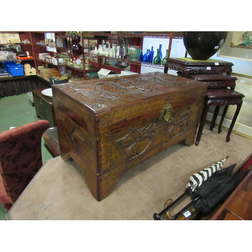 4009 - An Oriental heavily carved camphor wood chest, 97cm wide x 50cm deep x 57cm tall