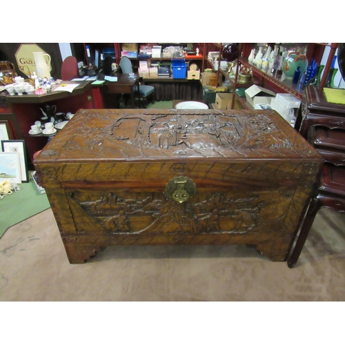 4009 - An Oriental heavily carved camphor wood chest, 97cm wide x 50cm deep x 57cm tall