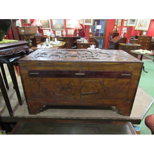 4009 - An Oriental heavily carved camphor wood chest, 97cm wide x 50cm deep x 57cm tall