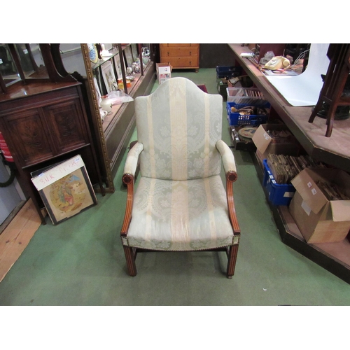 4174 - An early 19th Century inlaid mahogany Gainsborough armchair on brass castors