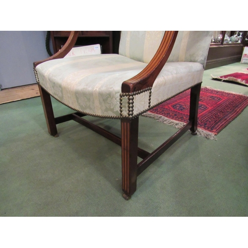 4174 - An early 19th Century inlaid mahogany Gainsborough armchair on brass castors