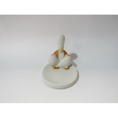 4251 - A Robj Porcelain of Paris ring dish surmounted with a figure of a Genie.  Printed marks to base.  10... 