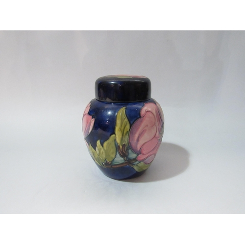 4260 - A Moorcroft lidded ginger jar , magnolia design, with label to base, 15cm tall.