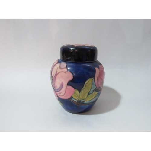 4260 - A Moorcroft lidded ginger jar , magnolia design, with label to base, 15cm tall.