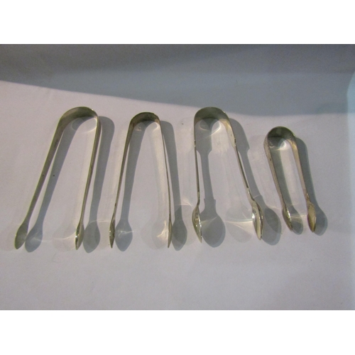 4392 - Three silver sugar nips, one white metal example (4)