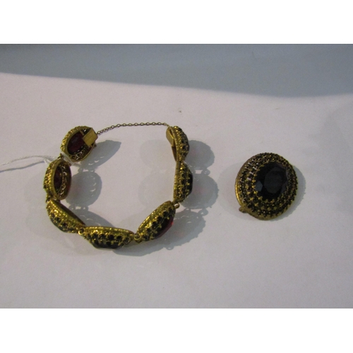 4403 - A Victorian gilt metal link bracelet with garnet coloured stones and matching brooch   (R) £20