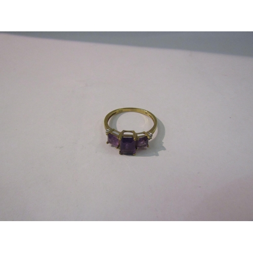 4422 - A gold ring set with three amethyst coloured stones flanked by diamond chips, stamped 9k. Size P, 1.... 