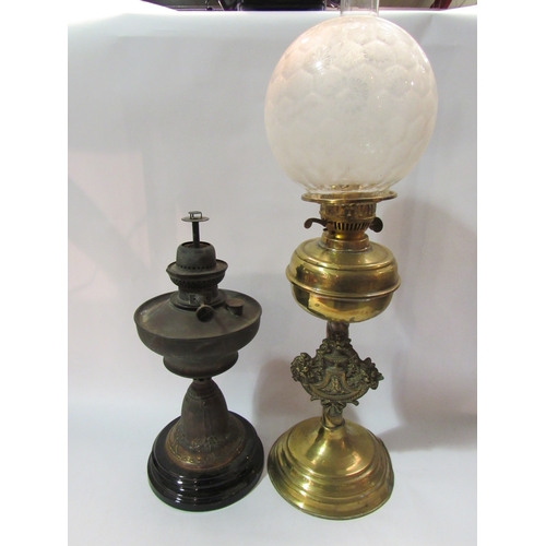 4287 - Two oil lamps including one with brass floral and bow design, glass shade