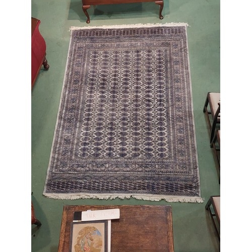 4513 - A blue ground geometric design rug with multiple borders and tasselled ends, 300cm x 194cm   (E) £50... 