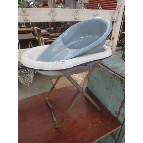 2317 - A French enamel baby bath/planter on folding metal stand and an enamel slipper pan