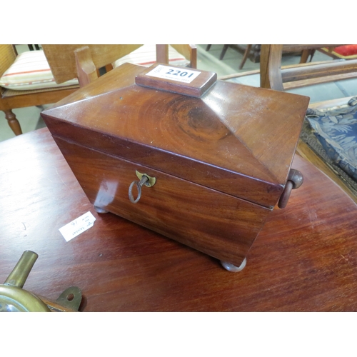 2222 - A Georgian flame mahogany scarcophagus shaped tea caddy with wooden ring handles and key            ... 