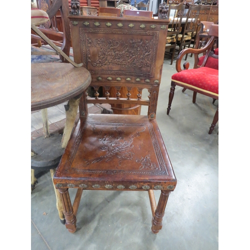 2214 - A 19th Century Continental walnut and leather hall chair with lions head decoration   (R) £30