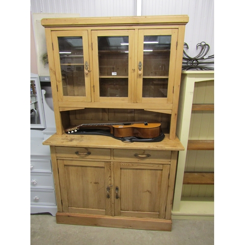 2336 - A Continental pine kitchen dresser with a two drawer over door base, glazed top and shelved interior