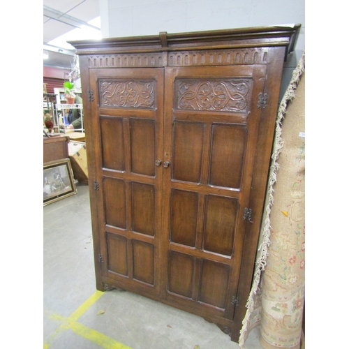 2115 - A carved oak two door wardrobe   (R) £40