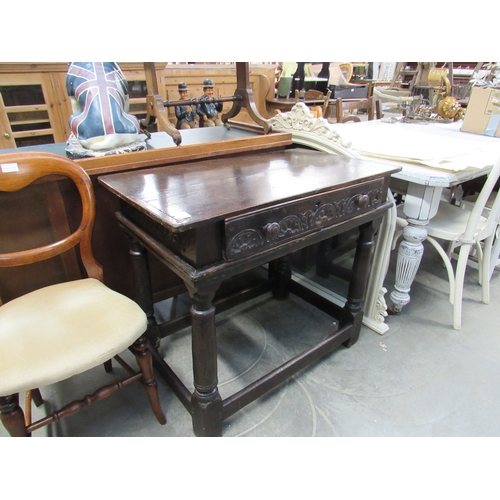 2282 - A Jacobean oak side table with carved drawer