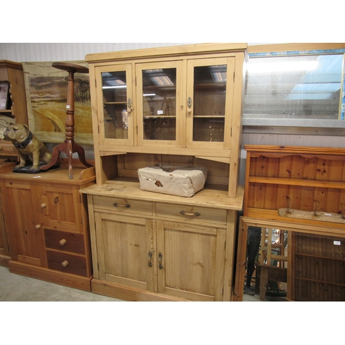 2336 - A Continental pine kitchen dresser with a two drawer over door base, glazed top and shelved interior