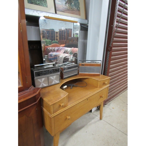 2429 - A 1960's oak dressing chest, the mirror back over alcove flanked by twin drawers, over single long d... 