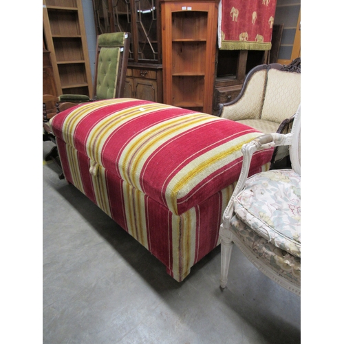 2459 - A large upholstered ottaman with strip upholstery, 63cm x 123cm x 68cm