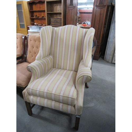 2465 - A Georgian style mahogany wingback armchair with stripe upholstery